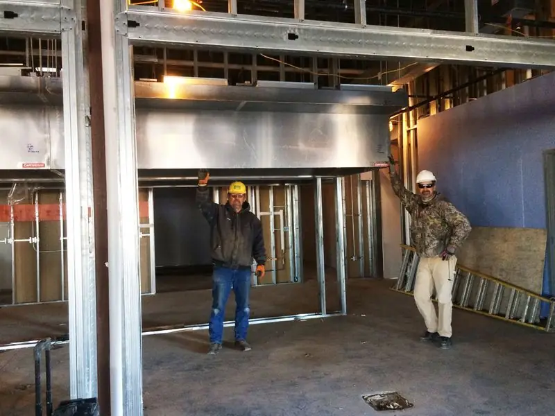 Two workers inside a commercial building under construction