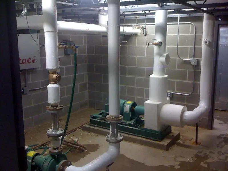 Pumps and insulated piping in a mechanical room