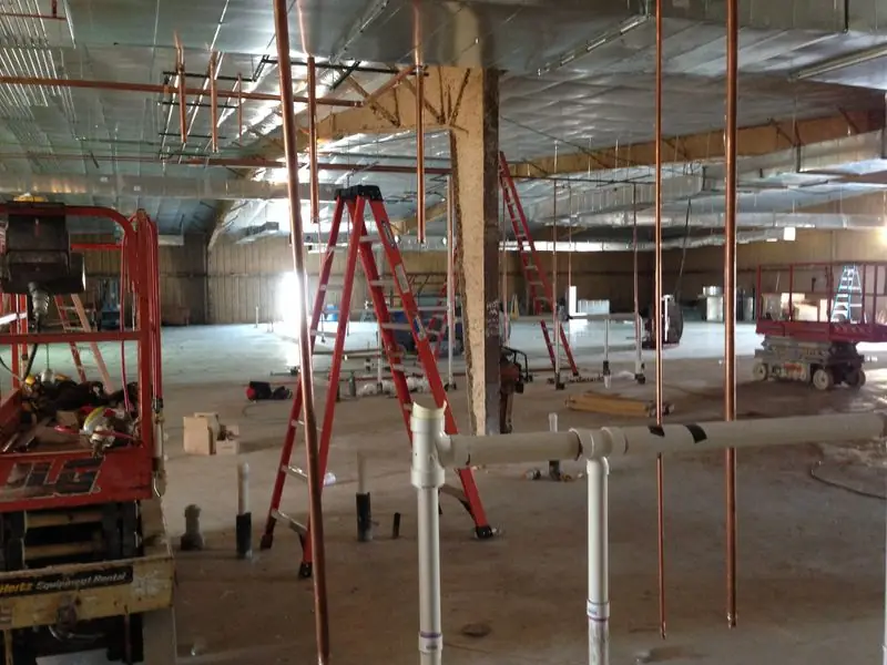 Plumbing rough-in inside a large commercial building