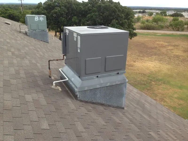 Packaged rooftop HVAC unit on a shingled roof