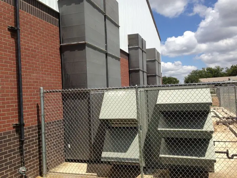 Large outdoor HVAC equipment beside a brick building
