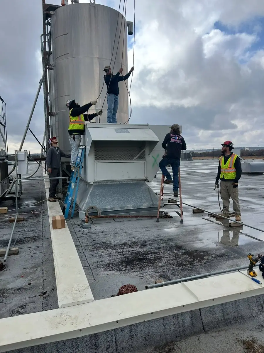 Crew working on rooftop equipment on a commercial building